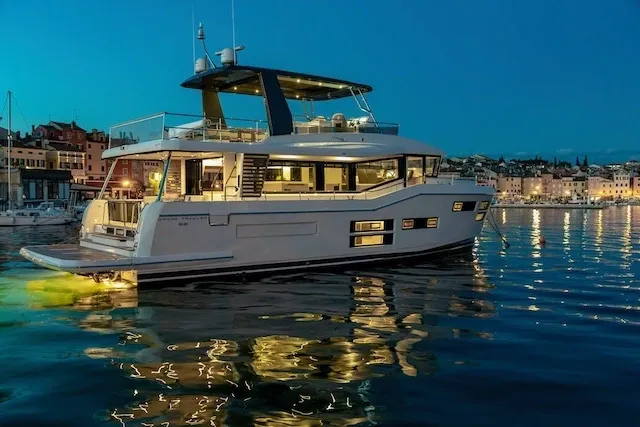 A large white boat floating on top of water.